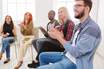 group of young man and woman clapping during their session