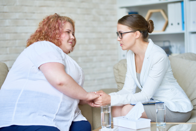 woman holding her therapist's hand